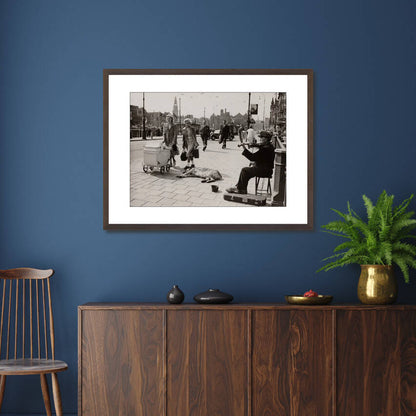 Zwart-witfoto uit 1950 van een straatviolist op een brug bij het Centraal Station in Amsterdam. – donkerbruine wissellijst in woonkamer