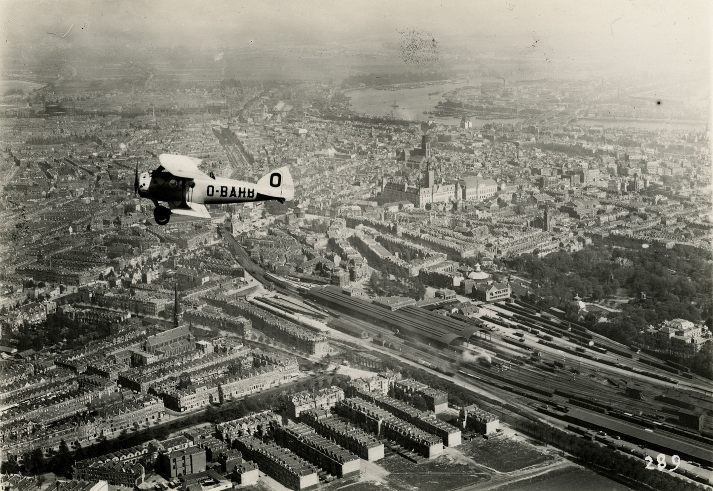 Historische foto van een vliegenier boven het centrum van Rotterdam rond 1923