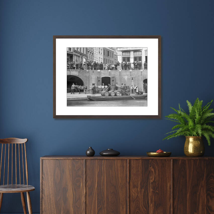 Zwart-witfoto uit 1906 van het overladen van wijnvaten aan de Oudegracht in Utrecht. – donkerbruine wissellijst in woonkamer